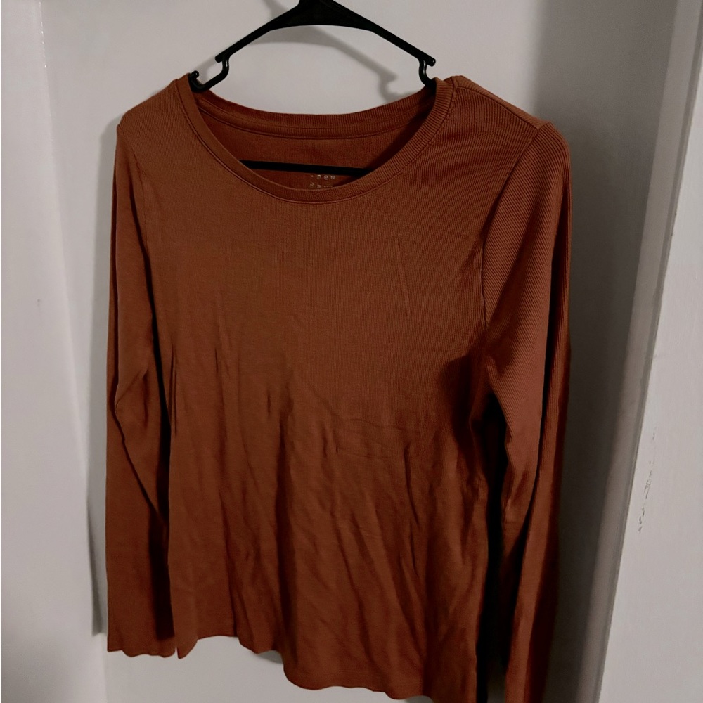 Burnt orange, long sleeve, ribbed shirt.